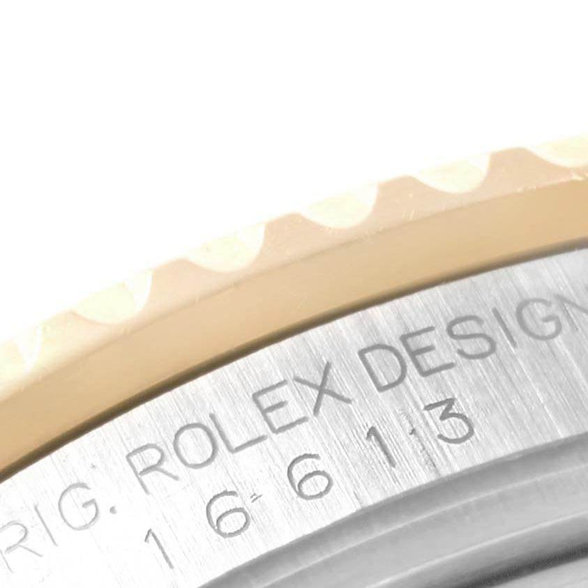 The image shows a close-up of the side of a Rolex Submariner 16613 Men's Steel and Gold (two tone) Blue Dial 16613 Men's Steel and Gold (two tone) Blue Dial, highlighting the engraved model number and bezel edge.