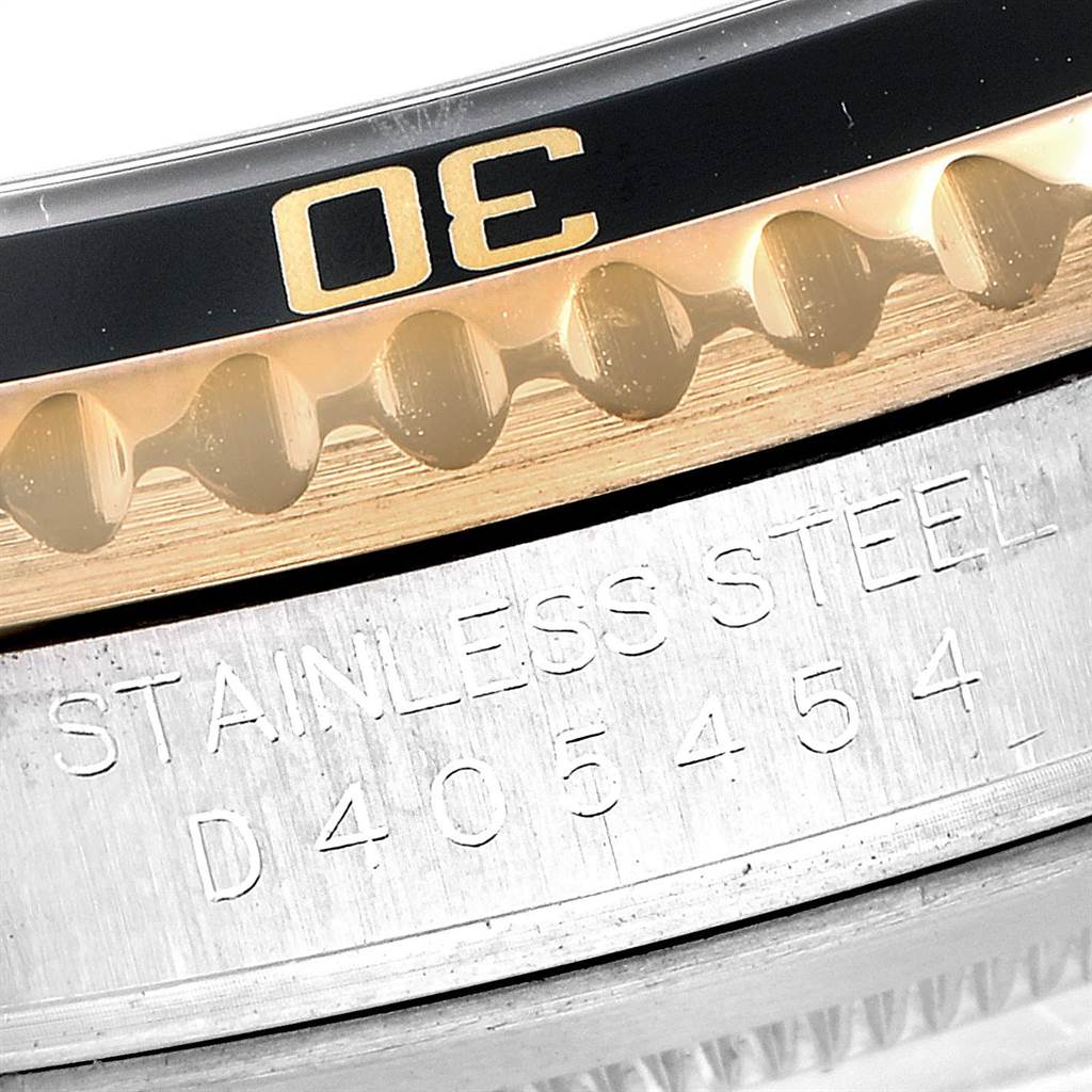 This image shows a close-up angle of the bezel, bezel teeth, and a part of the case back of a Rolex Submariner 16613 Men
s Steel and Gold (two tone) Black Dial 16613 Men
s Steel and Gold (two tone) Black Dial watch.