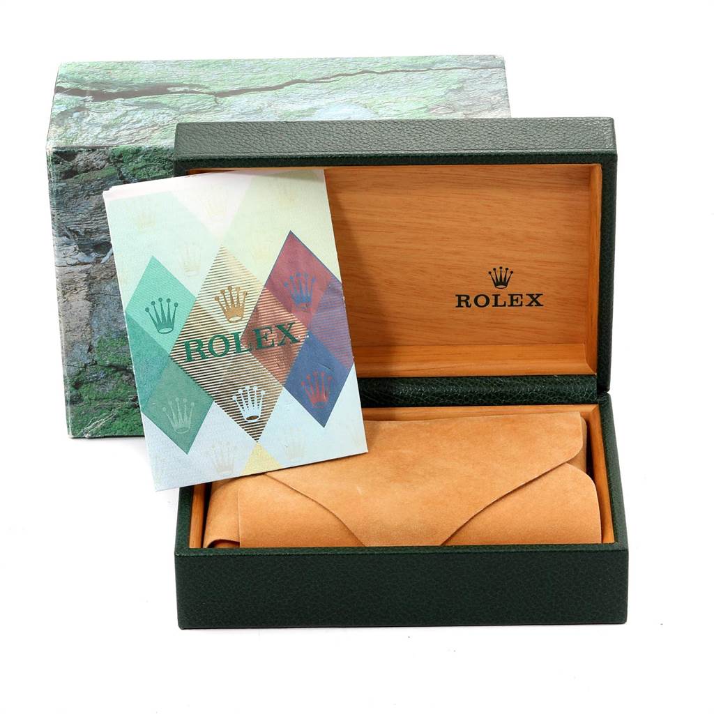 The image shows the packaging of a Rolex Submariner 16613 Men
s Steel and Gold (two tone) Black Dial 16613 Men
s Steel and Gold (two tone) Black Dial watch, including an open box, a cloth pouch, and a booklet on top.