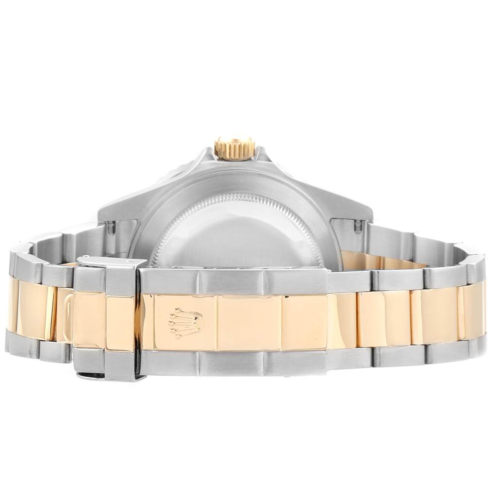 The image shows the back of a Rolex Submariner 16613 Men
s Steel and Gold (two tone) Blue Dial 16613 Men
s Steel and Gold (two tone) Blue Dial watch, highlighting its two-tone bracelet and clasp.