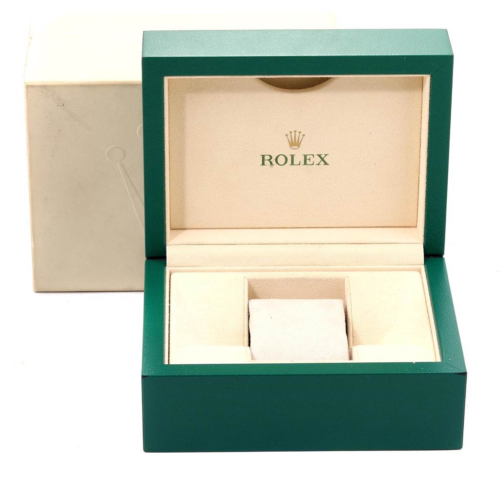 The image shows an open green and beige Rolex watch box for the Submariner model.