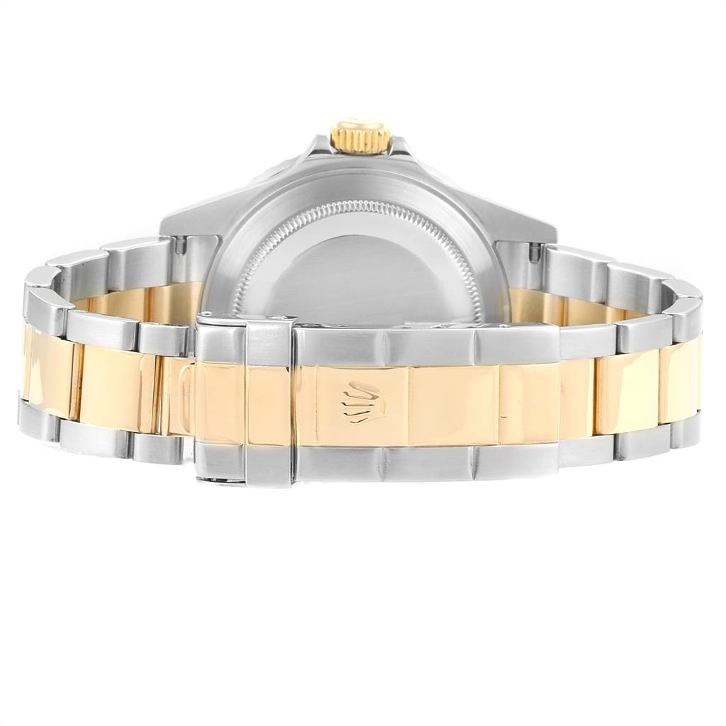 The photo shows the back view of a Rolex Submariner 16613 Men
s Steel and Gold (two tone) Blue Dial 16613 Men
s Steel and Gold (two tone) Blue Dial watch, highlighting its bracelet and clasp.