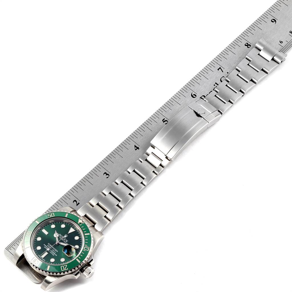This image shows a Rolex Submariner 116610LV Men
s Stainless Steel Green Dial 116610LV Men
s Stainless Steel Green Dial watch laid flat alongside a ruler to measure its bracelet length.
