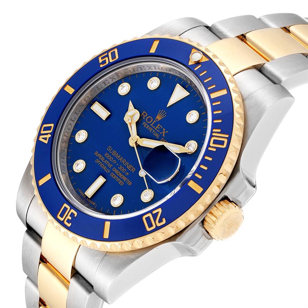 This image shows a Rolex Submariner 116613 Men
s Steel and Gold (two tone) Blue Dial 116613 Men
s Steel and Gold (two tone) Blue Dial watch from a slight angle, displaying its blue dial, gold bezel, and two-tone bracelet.