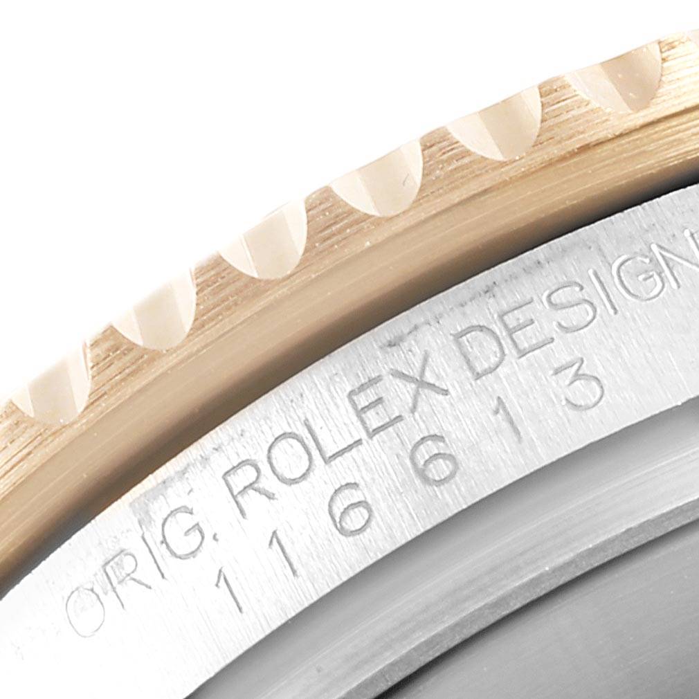 The image shows a close-up of the bezel and portion of the case back engraving of a Rolex Submariner 116613 Men
s Steel and Gold (two tone) Blue Dial 116613 Men
s Steel and Gold (two tone) Blue Dial watch.