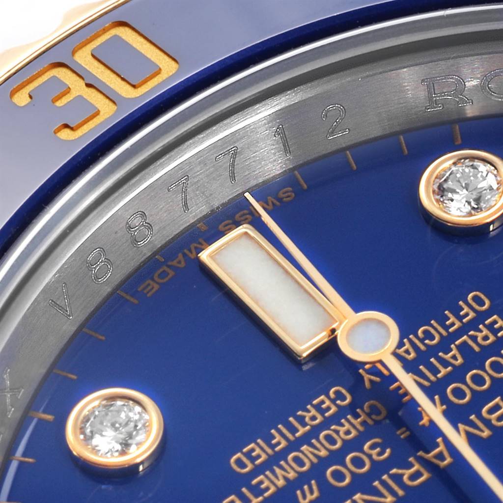 This close-up image of a Rolex Submariner 116613 Men
s Steel and Gold (two tone) Blue Dial 116613 Men
s Steel and Gold (two tone) Blue Dial watch showcases part of the blue dial, bezel with the number 30, and diamond hour markers.