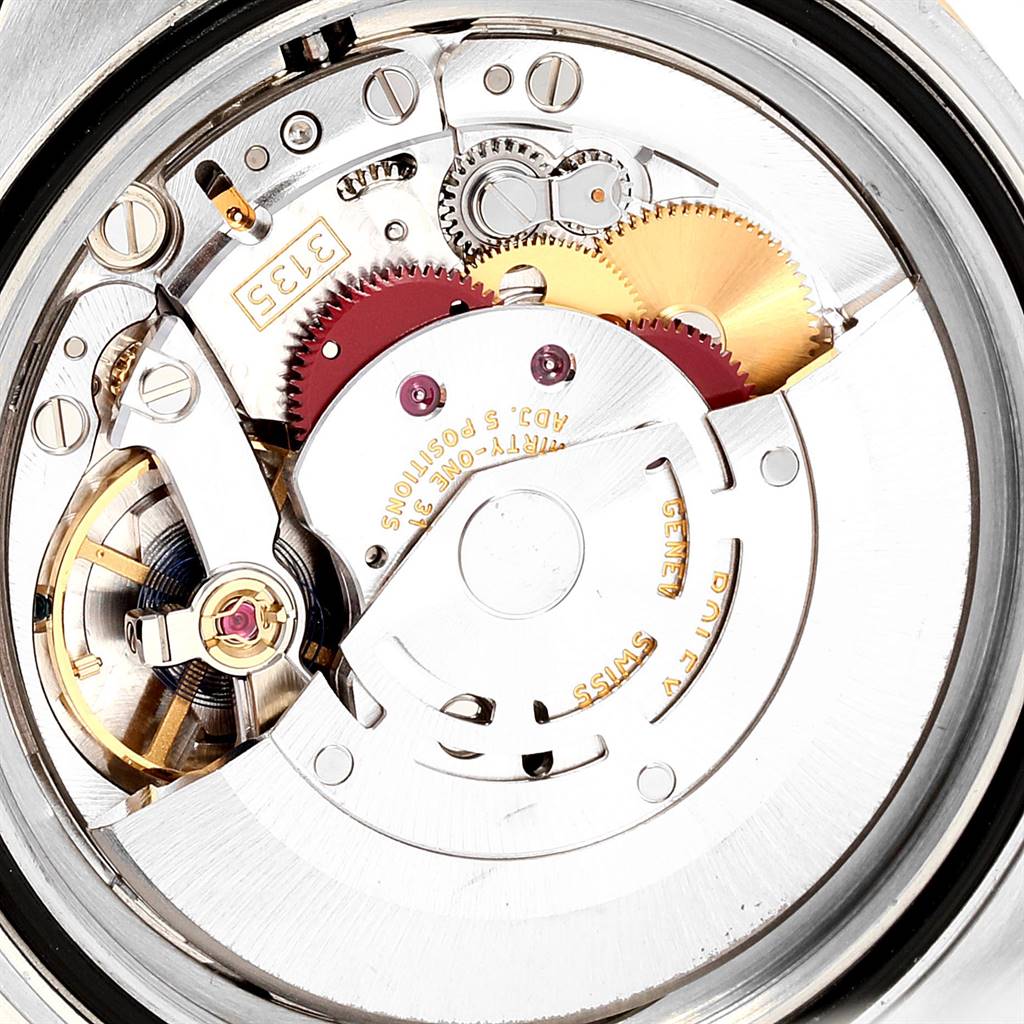 The image shows an interior view of the Rolex Submariner 116613 Men
s Steel and Gold (two tone) Blue Dial 116613 Men
s Steel and Gold (two tone) Blue Dial
s movement, highlighting its gears and mechanical components.