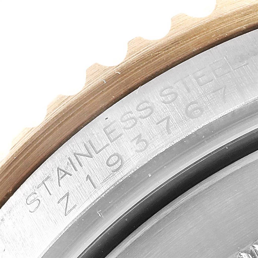 This image shows a close-up of the bezel edge and the engraving on the case back of a Rolex Submariner 16613 Men's Steel and Gold (two tone) Blue Dial 16613 Men's Steel and Gold (two tone) Blue Dial watch.