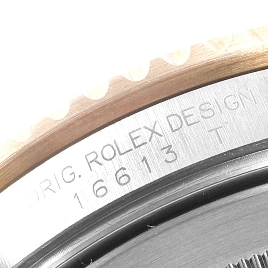 The image shows a close-up of the bezel and engraved outer casing of a Rolex Submariner 16613 Men's Steel and Gold (two tone) Blue Dial 16613 Men's Steel and Gold (two tone) Blue Dial watch, model number 16613.