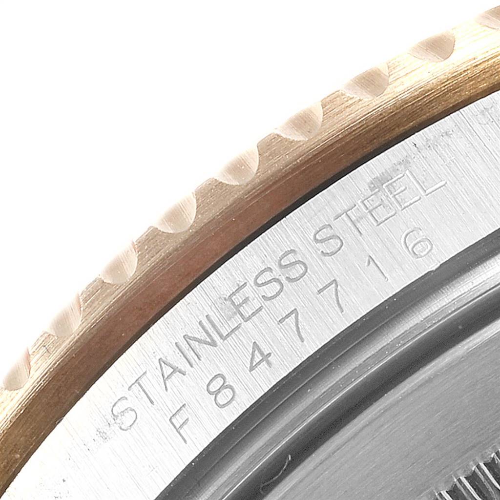 This image shows a close-up of the side and back of a stainless steel Rolex Submariner 16613 Men's Steel and Gold (two tone) Blue Dial 16613 Men's Steel and Gold (two tone) Blue Dial watch with its serial number.