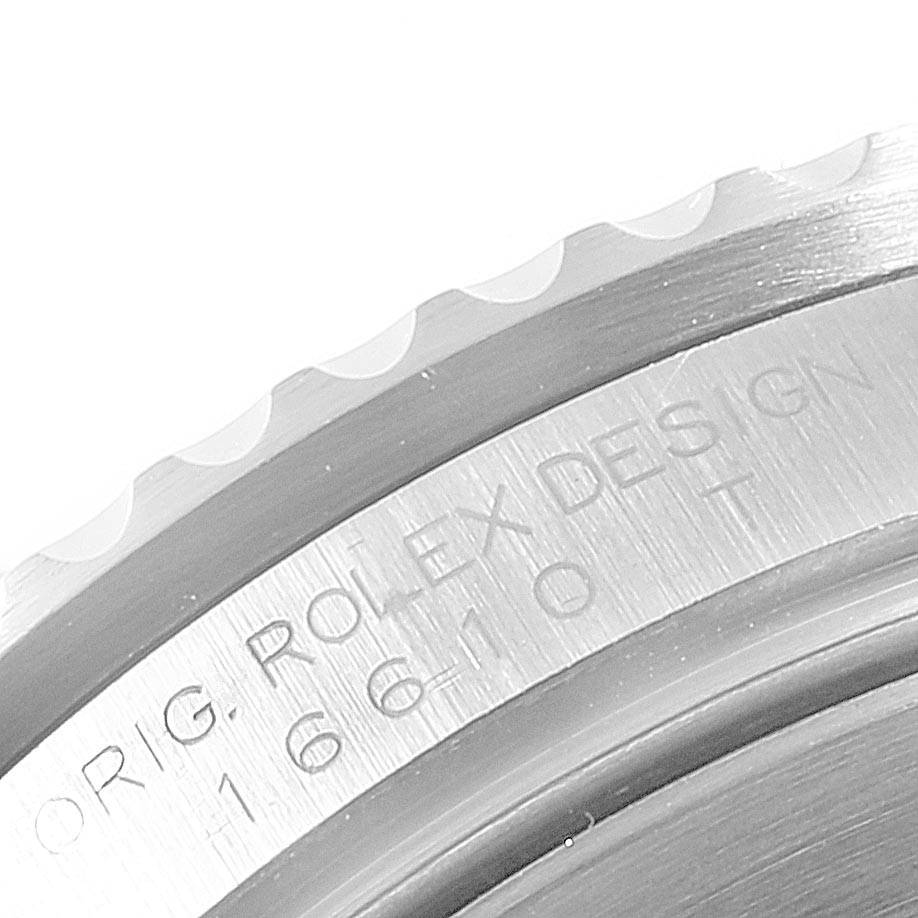 This image shows a close-up of the engraved side of the case and the bezel of a Rolex Submariner 16610 Men
s Stainless Steel Black Dial 16610 Men
s Stainless Steel Black Dial.