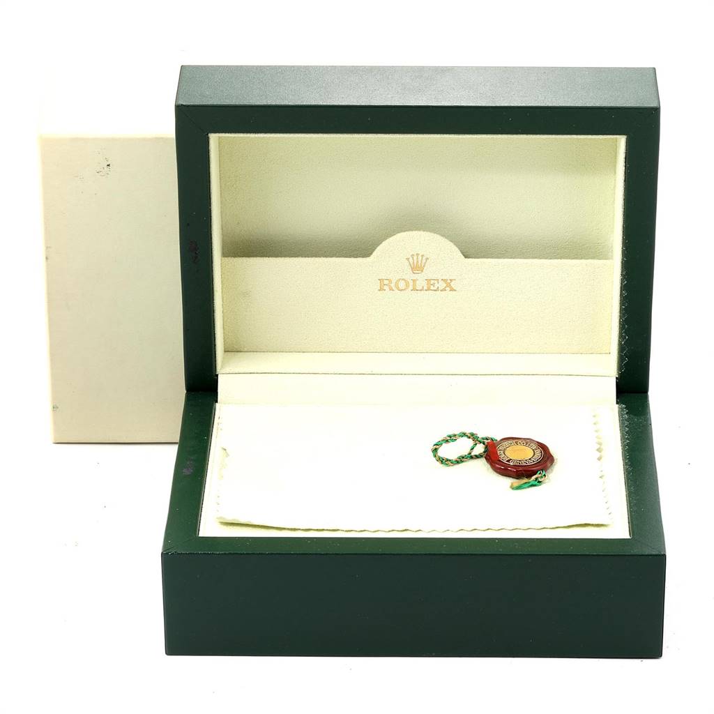 This image shows an open Rolex Submariner 16610 Men
s Stainless Steel Black Dial 16610 Men
s Stainless Steel Black Dial watch box with its tag and a cleaning cloth inside, viewed from the front.