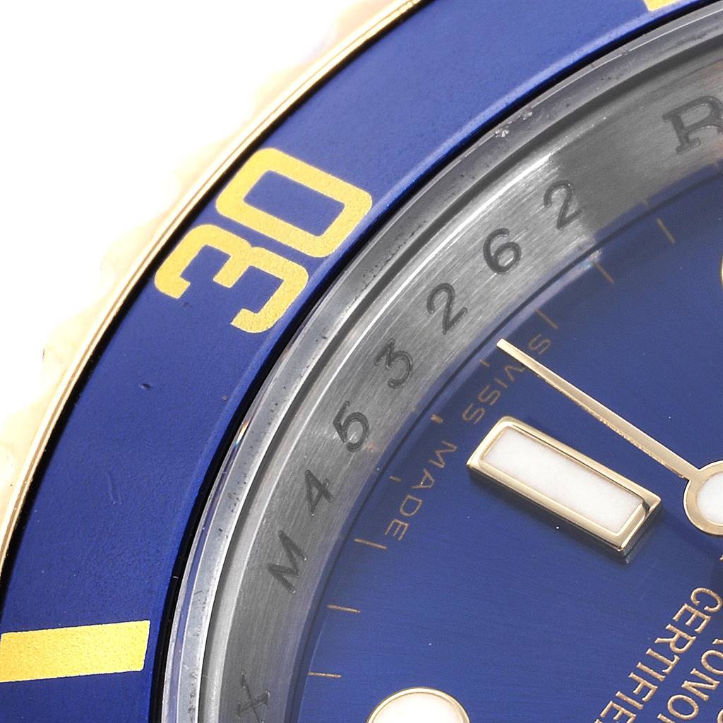 The image shows a close-up of the bezel, dial, and part of the hand of a Rolex Submariner 16613 Men
s Steel and Gold (two tone) Blue Dial 16613 Men
s Steel and Gold (two tone) Blue Dial watch.