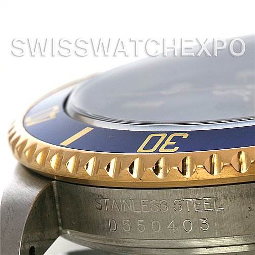 The image shows a close-up of the bezel and stainless steel casing of a Rolex Submariner 16613 Men's Yellow Gold Blue Dial 16613 Men's Yellow Gold Blue Dial watch from a side angle.