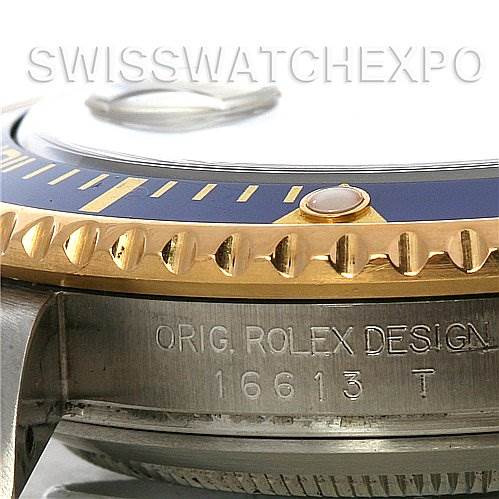 The image shows a close-up of the side bezel, part of the crown, and case engravings of the Rolex Submariner 16613 Men's Yellow Gold Blue Dial 16613 Men's Yellow Gold Blue Dial model 16613.