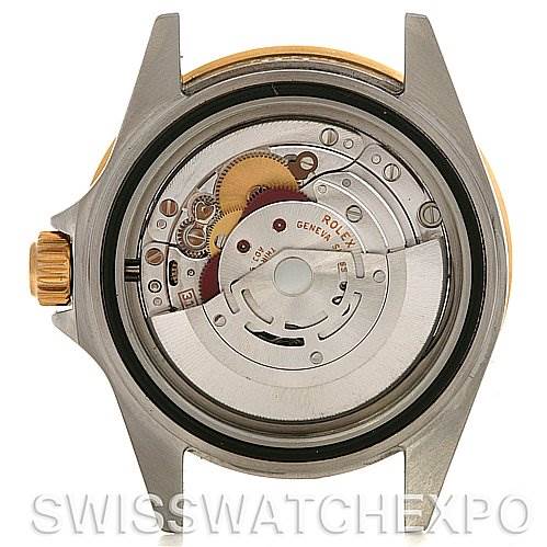 This image shows the open back of a Rolex Submariner 16613 Men's Yellow Gold Blue Dial 16613 Men's Yellow Gold Blue Dial watch, displaying the intricate inner mechanics and movement.