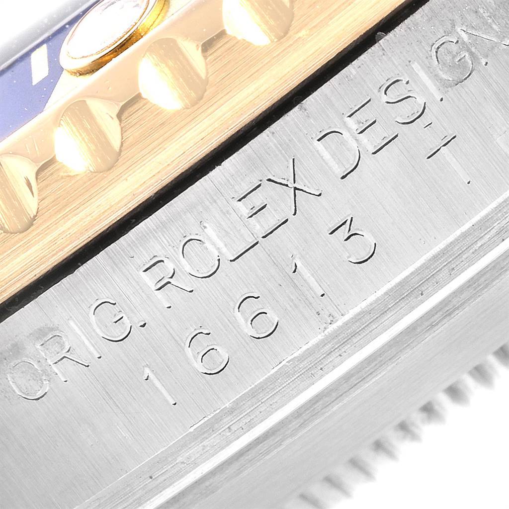 The image shows the side view of a Rolex Submariner 16613 Men's Steel and Gold (two tone) Blue Dial 16613 Men's Steel and Gold (two tone) Blue Dial case, highlighting the engraved model number "16613" and part of the bezel.
