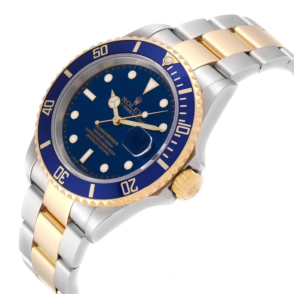 The image shows the Rolex Submariner 16613 Men's Steel and Gold (two tone) Blue Dial 16613 Men's Steel and Gold (two tone) Blue Dial model watch at an oblique angle, highlighting the face, bezel, crown, and two-tone bracelet.