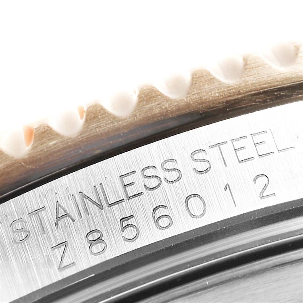 Close-up of the Rolex Submariner 16613 Men's Steel and Gold (two tone) Blue Dial 16613 Men's Steel and Gold (two tone) Blue Dial's bezel and engraved stainless steel casing.