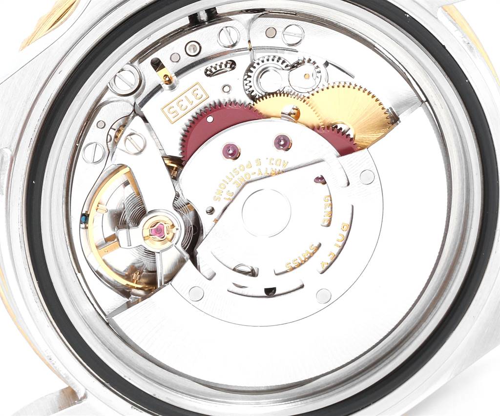 The image shows a close-up of the movement mechanism of a Rolex Submariner 16613 Men's Steel and Gold (two tone) Blue Dial 16613 Men's Steel and Gold (two tone) Blue Dial watch, focusing on its intricate gears and components.
