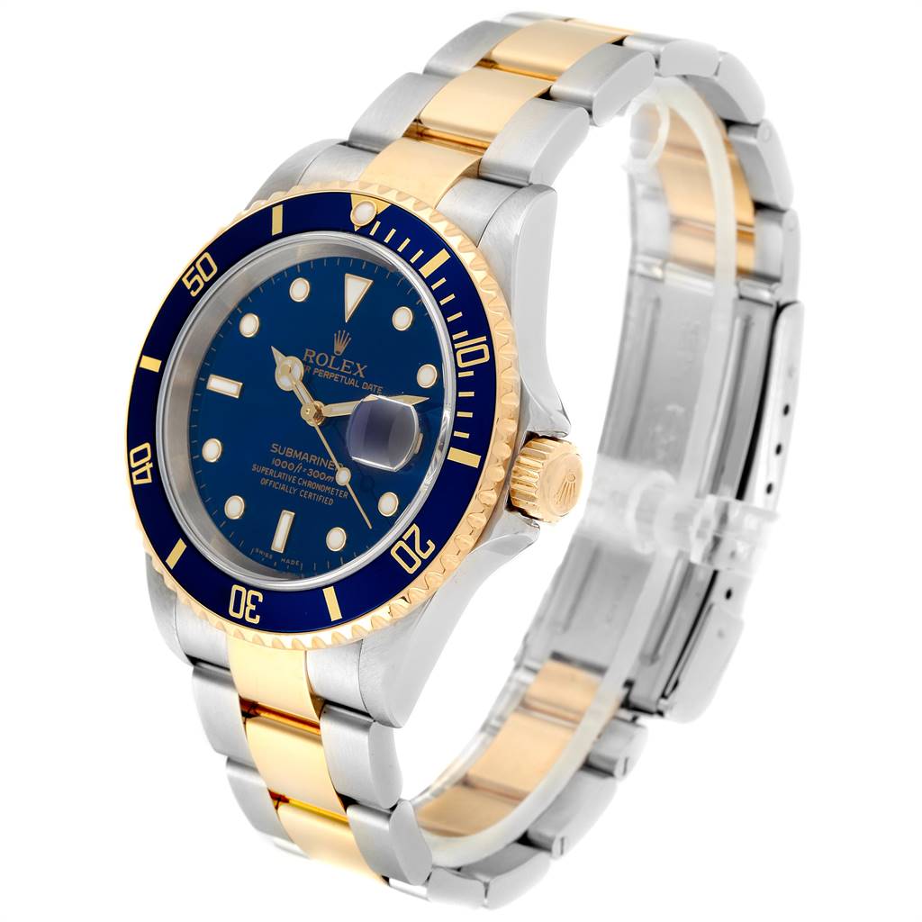 The image shows a Rolex Submariner 16613 Men
s Steel and Gold (two tone) Blue Dial 16613 Men
s Steel and Gold (two tone) Blue Dial watch at a slight angle, highlighting its blue dial, gold bezel, and two-tone metal bracelet.