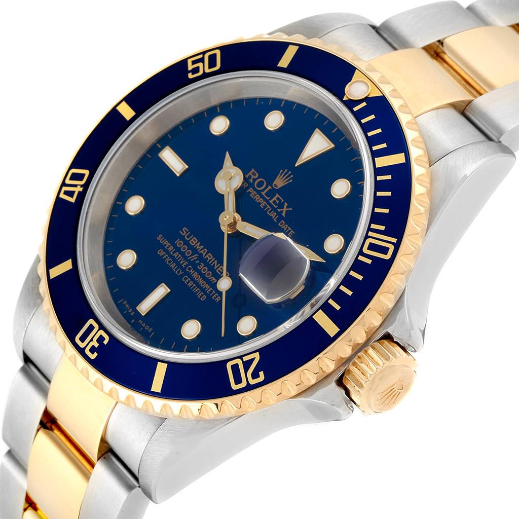 The image shows a Rolex Submariner 16613 Men
s Steel and Gold (two tone) Blue Dial 16613 Men
s Steel and Gold (two tone) Blue Dial watch at an angled top view, highlighting the bezel, face, crown, and part of the bracelet.