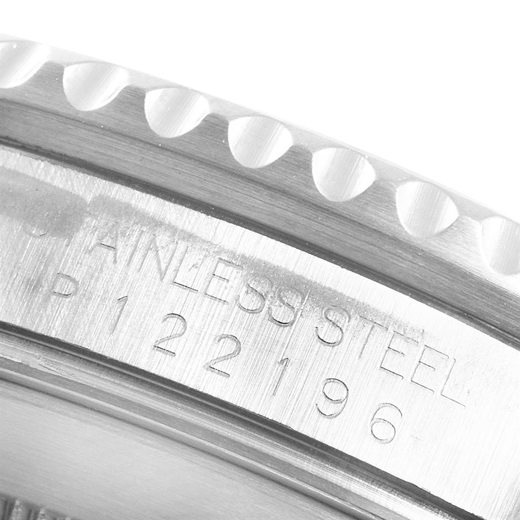 The image shows a close-up of the side engraving, featuring the serial number on the stainless steel case edge of the Rolex Submariner 16610 Men's Stainless Steel Black Dial 16610 Men's Stainless Steel Black Dial.