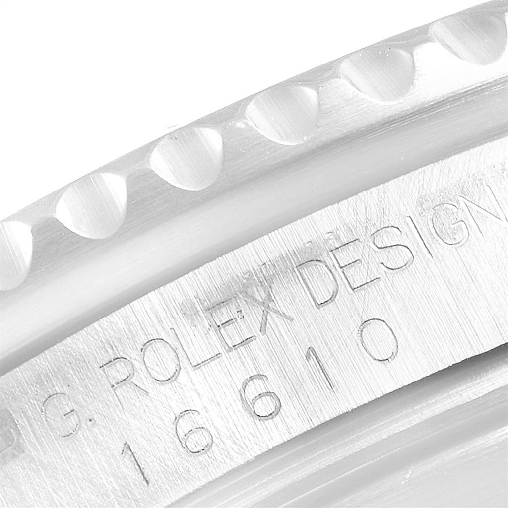 The image shows a close-up of the Rolex Submariner 16610 Men
s Stainless Steel Black Dial 16610 Men
s Stainless Steel Black Dial model
s bezel edge and engraved model number.