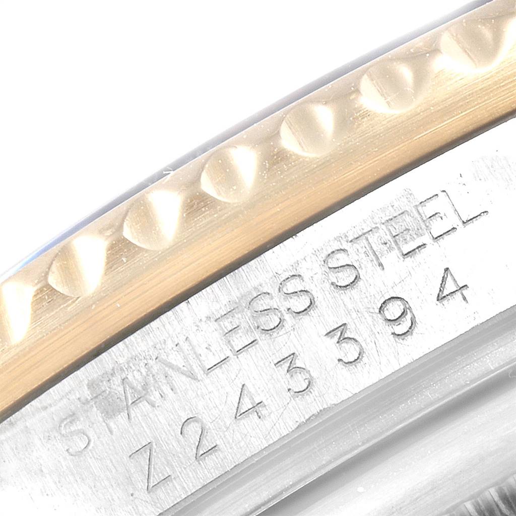 This close-up image shows the engraved serial number and stainless steel marking on the bezel edge of a Rolex Submariner 16613 Men's Steel and Gold (two tone) Champagne Dial 16613 Men's Steel and Gold (two tone) Champagne Dial watch.