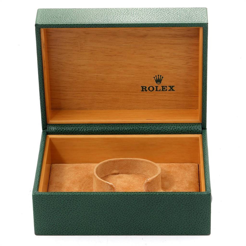 This image shows an open Rolex Submariner 16613 Men's Steel and Gold (two tone) Champagne Dial 16613 Men's Steel and Gold (two tone) Champagne Dial watch box with a green exterior and wooden interior.