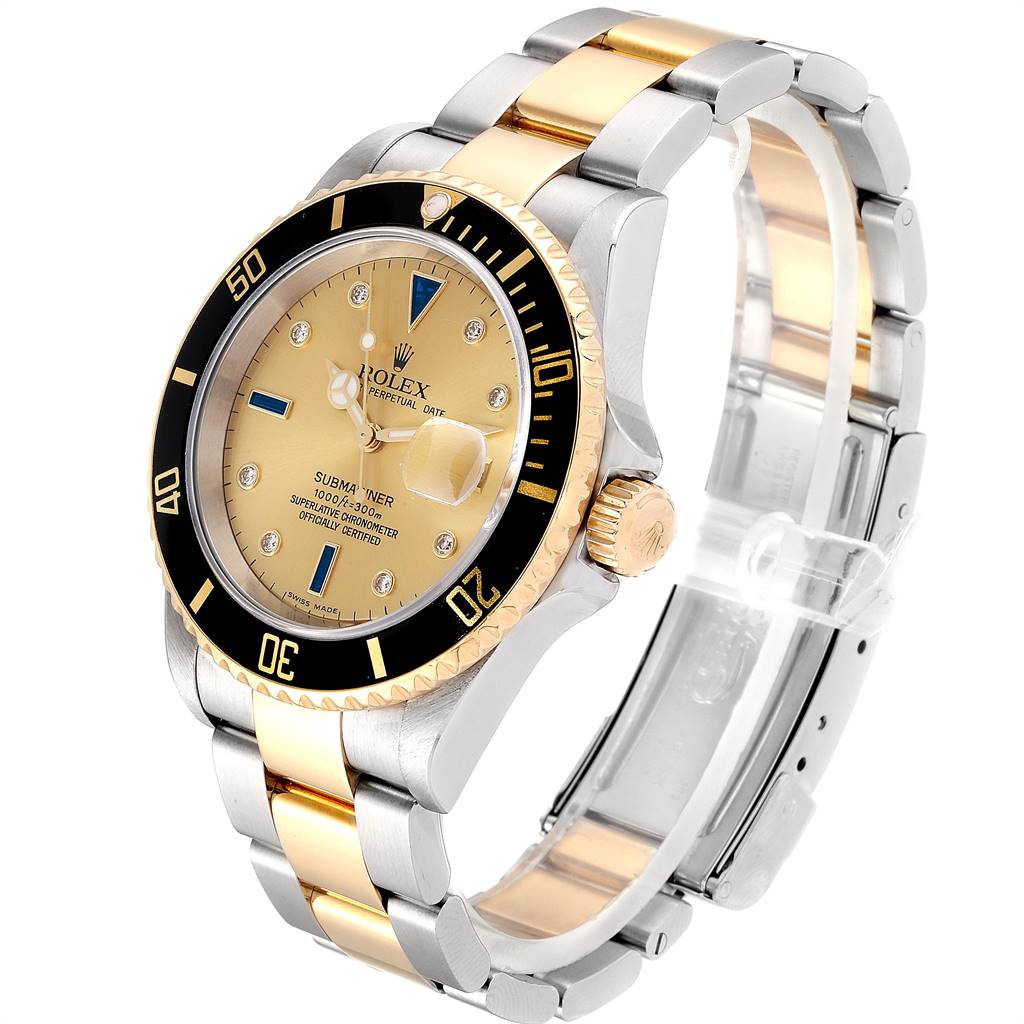 The image shows a Rolex Submariner 16613 Men's Steel and Gold (two tone) Champagne Dial 16613 Men's Steel and Gold (two tone) Champagne Dial watch at a slight angle, featuring its dial, bezel, crown, and two-tone bracelet.
