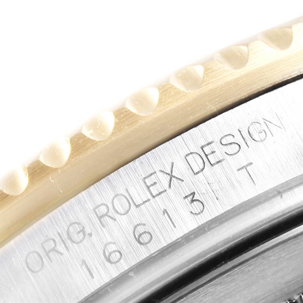 Close-up of the Rolex Submariner 16613 Men
s Steel and Gold (two tone) Grey Dial 16613 Men
s Steel and Gold (two tone) Grey Dial model showing the engraved bezel and serial number on the case.