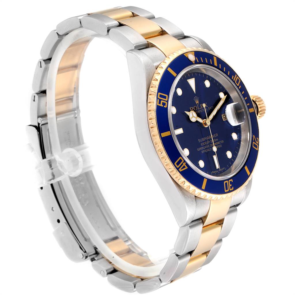 The Rolex Submariner 16613 Men
s Steel and Gold (two tone) Blue Dial 16613 Men
s Steel and Gold (two tone) Blue Dial watch is shown at an oblique angle, highlighting its blue dial, bezel, and two-tone metal bracelet.