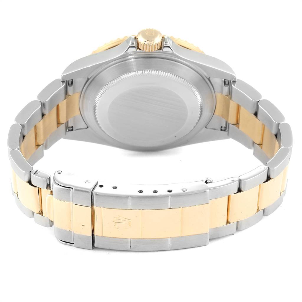 The image shows the back view of a Rolex Submariner 16613 Men
s Steel and Gold (two tone) Blue Dial 16613 Men
s Steel and Gold (two tone) Blue Dial, highlighting the case back, crown, and two-tone bracelet.