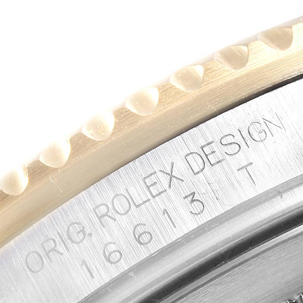 Close-up of the bezel, case, and engraved serial number on a Rolex Submariner 16613 Men
s Steel and Gold (two tone) Blue Dial 16613 Men
s Steel and Gold (two tone) Blue Dial watch.