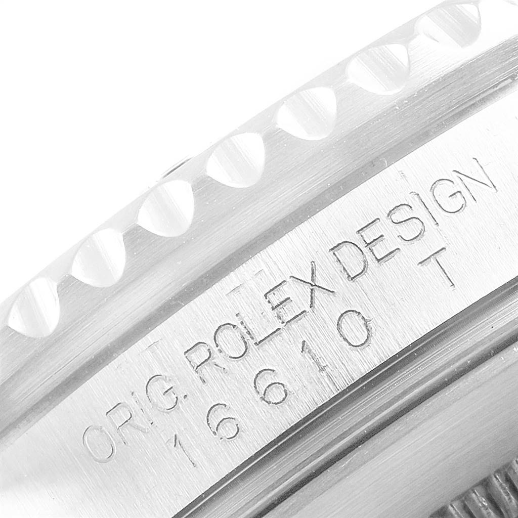 The image shows a close-up of the case side of a Rolex Submariner 16610 Men
s Stainless Steel Black Dial 16610 Men
s Stainless Steel Black Dial watch, focusing on the engraved model number and design details.