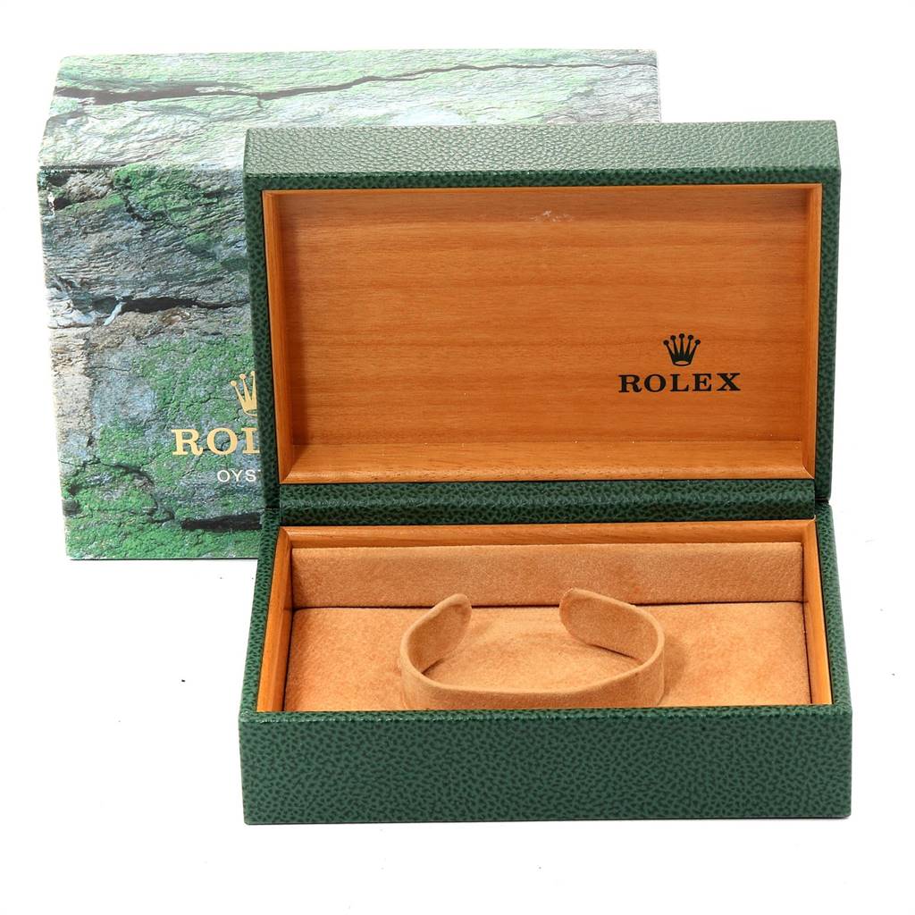 The image shows an open Rolex watch box for the Submariner model, revealing a brown cushion for the watch but with no watch inside.