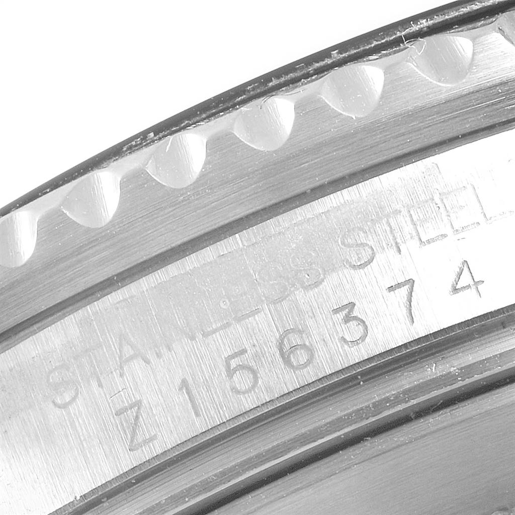 This close-up image showcases the engraved serial number and stainless steel marking on the side of a Rolex Submariner 16610 Men
s Stainless Steel Black Dial 16610 Men
s Stainless Steel Black Dial watch case.