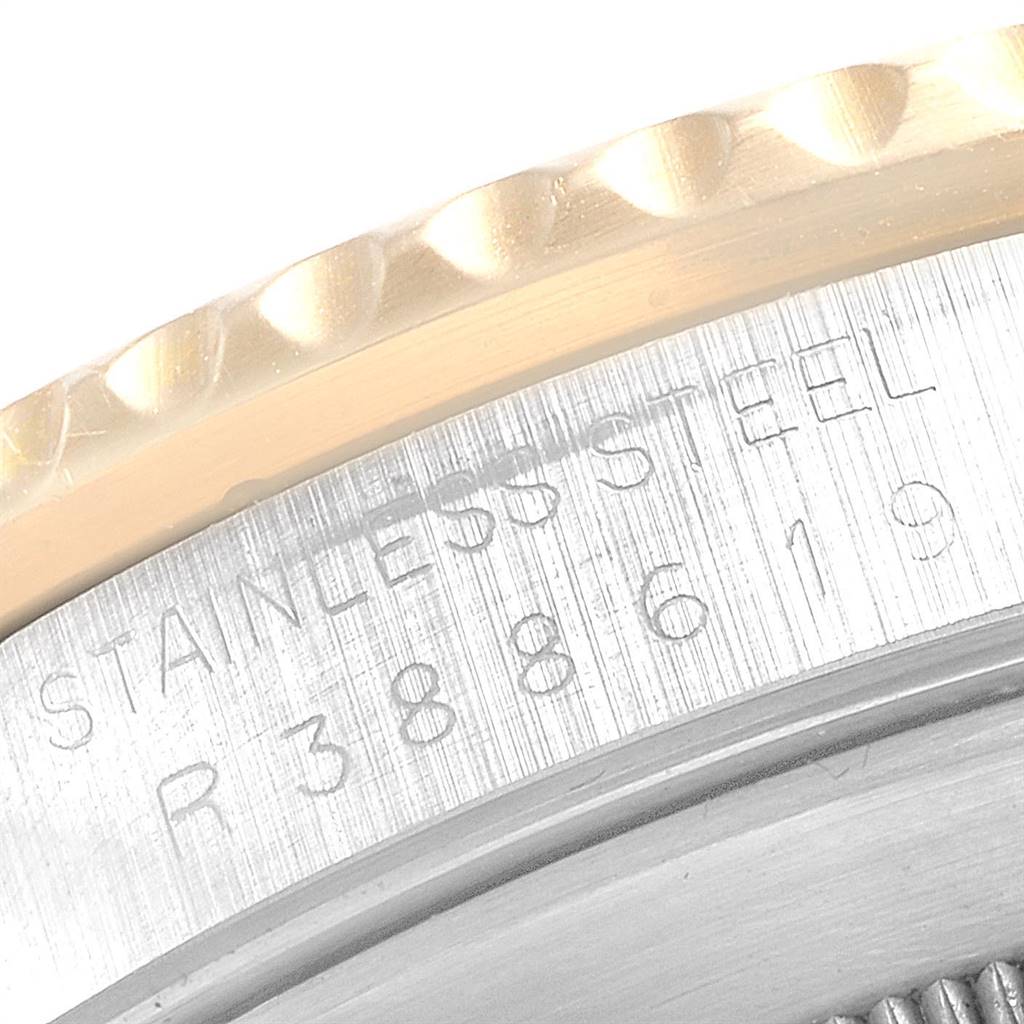 This close-up shows the engraved stainless steel case back and edge of the bezel of the Rolex Submariner 16803 Men
s Steel and Gold (two tone) Black Dial 16803 Men
s Steel and Gold (two tone) Black Dial watch.