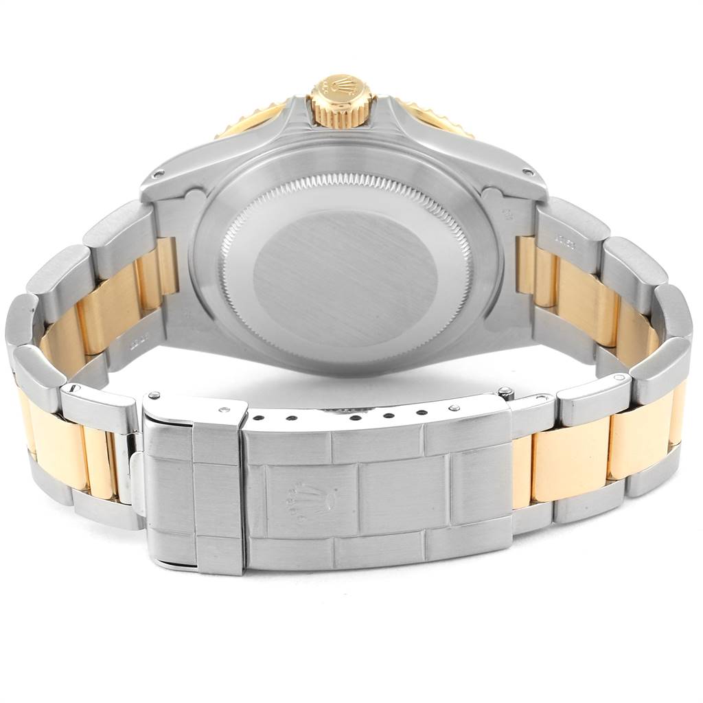 This image shows the back case, crown, and clasp of the Rolex Submariner 16803 Men
s Steel and Gold (two tone) Black Dial 16803 Men
s Steel and Gold (two tone) Black Dial, including the metal bracelet with gold and silver links.