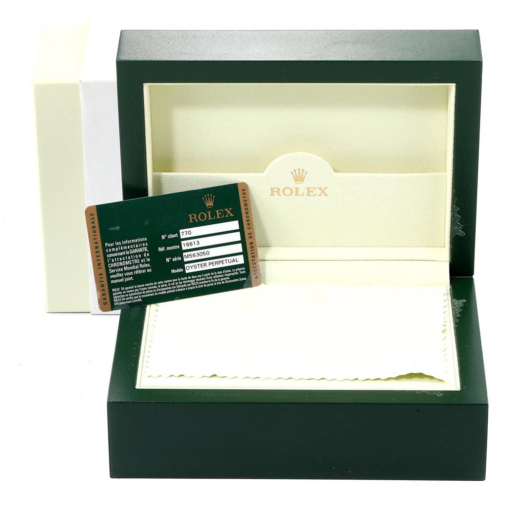The image shows an open Rolex watch box for the Submariner model, along with the warranty card displayed.