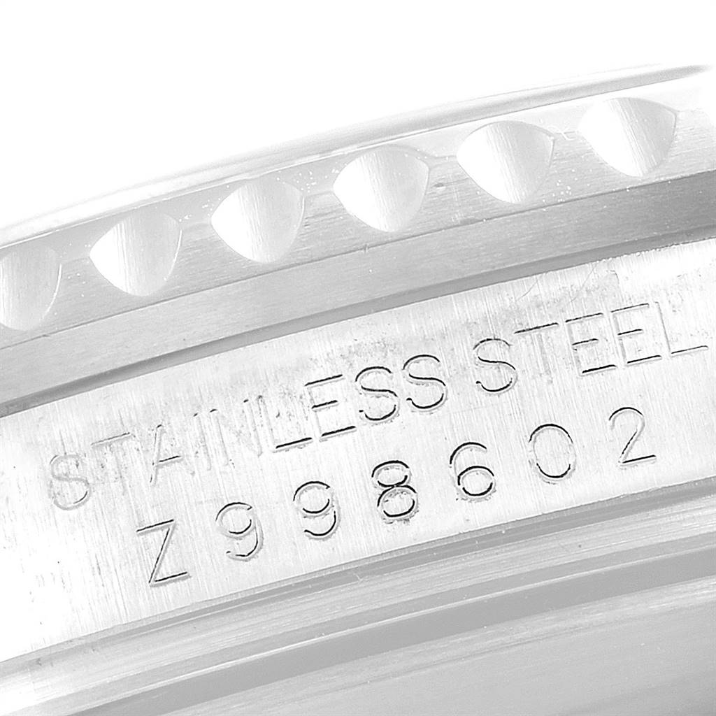 This close-up angle of the Rolex Submariner 16610LV Men
s Stainless Steel Black Dial 16610LV Men
s Stainless Steel Black Dial watch shows the stainless steel case with engraved text and part of the bezel.