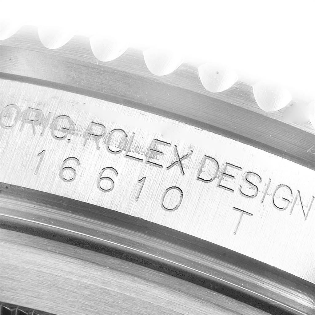 This image shows a close-up of the engraved case side of a Rolex Submariner 16610LV Men
s Stainless Steel Black Dial 16610LV Men
s Stainless Steel Black Dial model 16610.