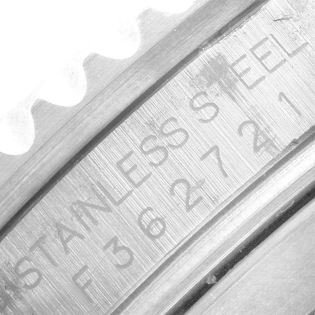 The image shows a close-up of the serial number and "STAINLESS STEEL" engraving on the inner bezel of a Rolex Submariner 16610 Men
s Stainless Steel Black Dial 16610 Men
s Stainless Steel Black Dial.