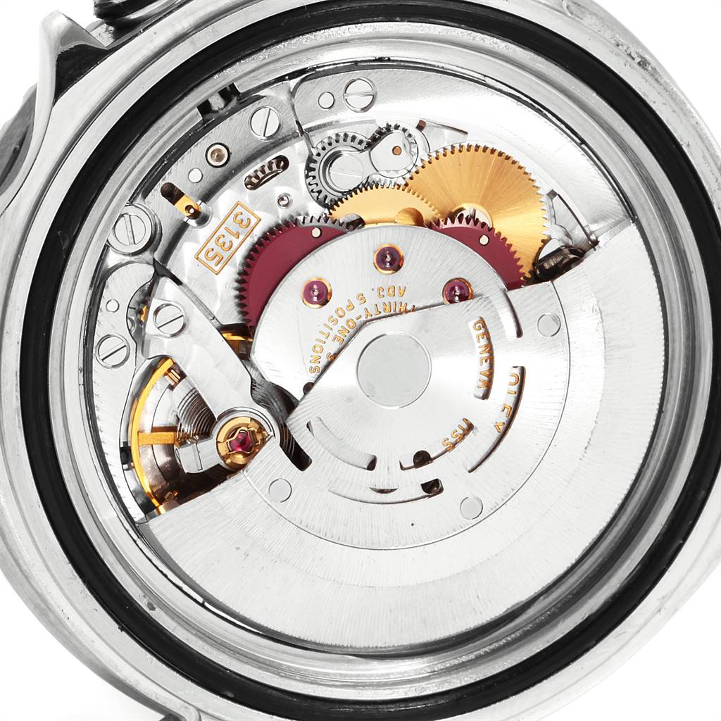 This image shows an internal view of the Rolex Submariner 16610 Men
s Stainless Steel Black Dial 16610 Men
s Stainless Steel Black Dial watch, highlighting its intricate mechanical movement and gears.