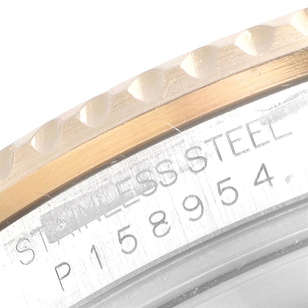 The image shows a close-up of the bezel and serial number engraving on a Rolex Submariner 16613 Men
s Steel and Gold (two tone) Blue Dial 16613 Men
s Steel and Gold (two tone) Blue Dial watch.