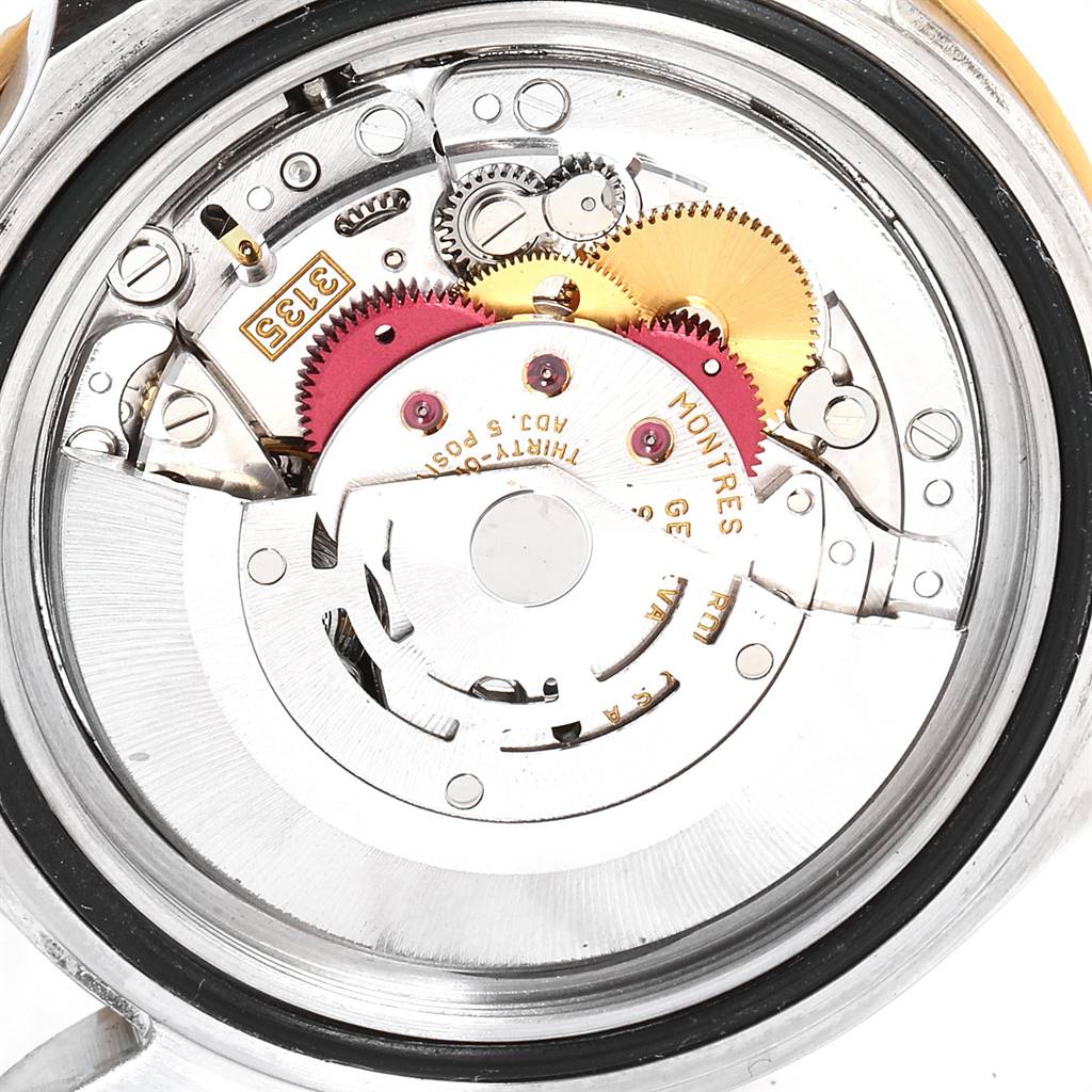 This image shows the mechanical movement and inner components of a Rolex Submariner 16613 Men
s Steel and Gold (two tone) Blue Dial 16613 Men
s Steel and Gold (two tone) Blue Dial watch from the back angle.