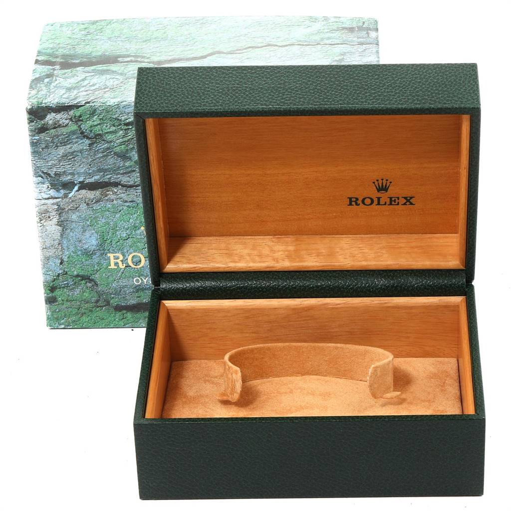 The image shows an empty Rolex watch box designed for a Submariner model, with a green exterior and wooden interior.