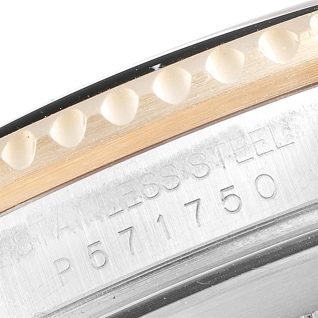 The image shows a close-up of the case side with the engraved serial number and part of the bezel of a Rolex Submariner 16613 Men's Steel and Gold (two tone) Black Dial 16613 Men's Steel and Gold (two tone) Black Dial watch.
