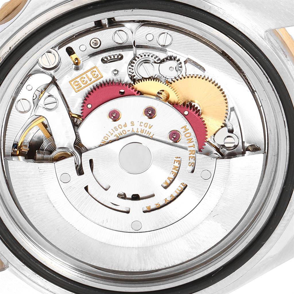The image shows the intricate internal mechanism of a Rolex Submariner 16613 Men's Steel and Gold (two tone) Black Dial 16613 Men's Steel and Gold (two tone) Black Dial watch from a back angle.